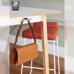 A bag hanging from a hook under the Allermuir Siltra table