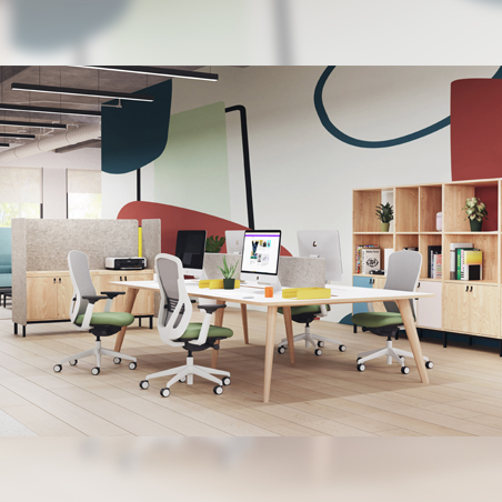 A group of Senator Ousby chairs with white frames and green seats arranged around a large workstation