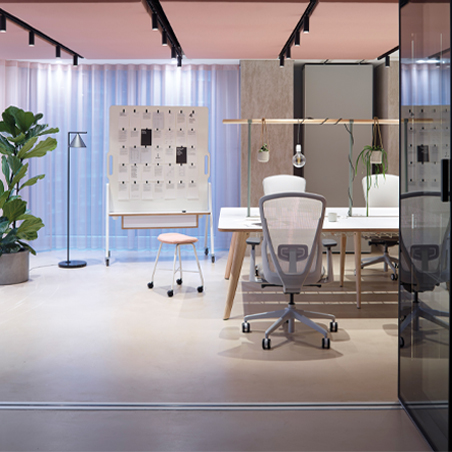 The Senator Ousby mesh office chair shown from the back in a stylish, modern office setting