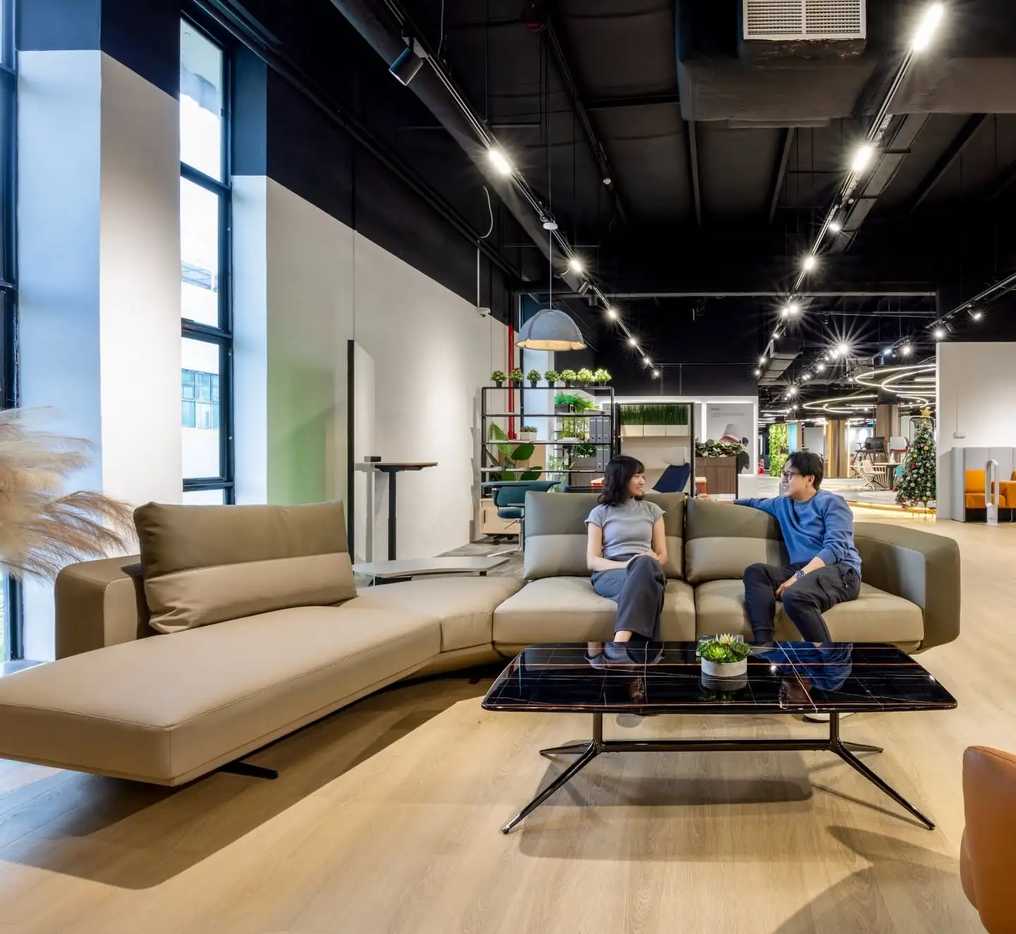 two people in conversation on a modular lounge sofa at DSolution Singapore showroom